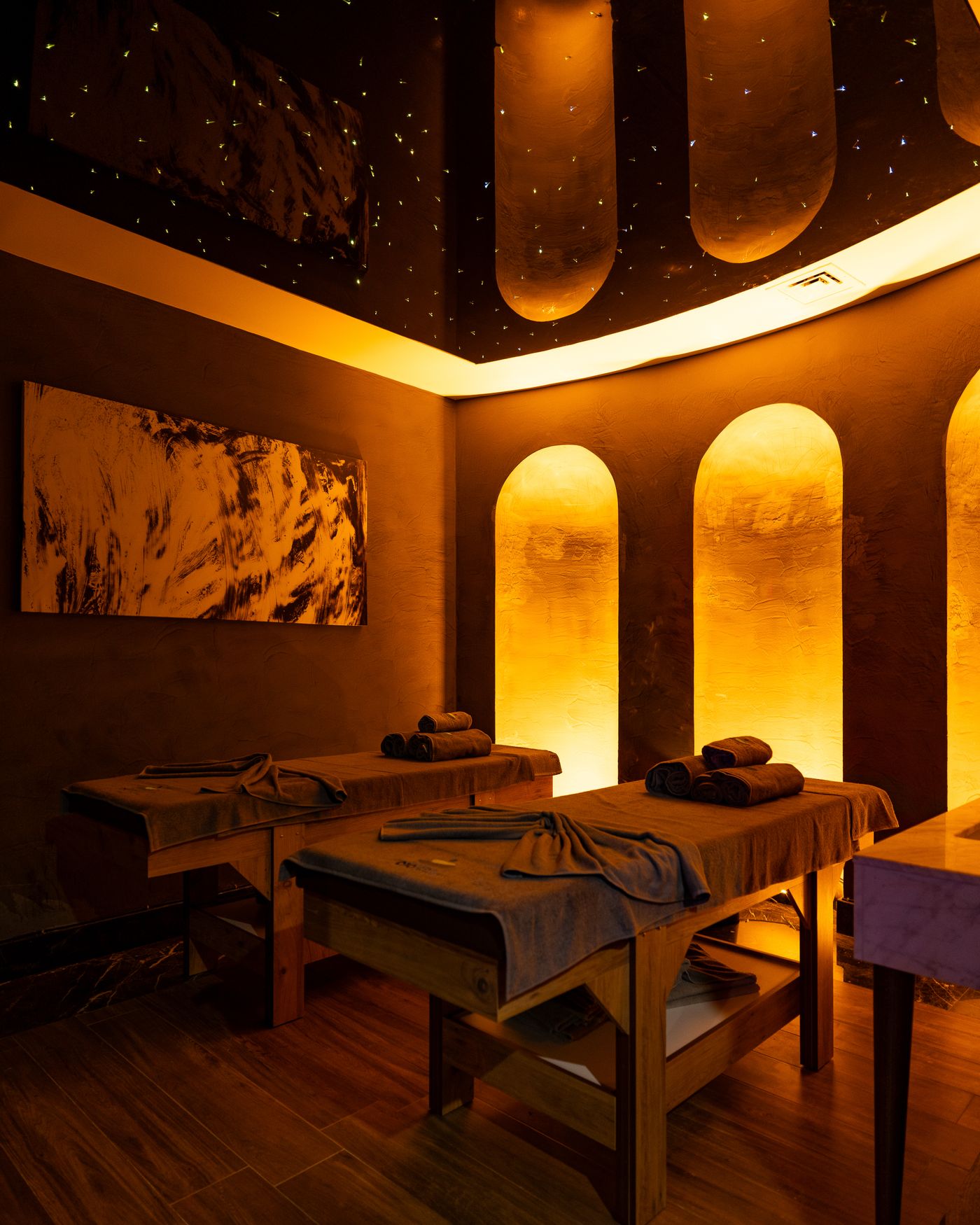 Warm, low-lit wellness room with comfortable spa furnishings